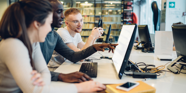 instructional design and technology students working at a computer