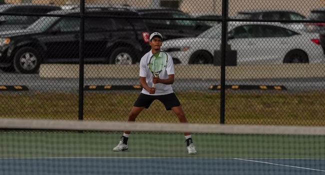 msmu men's tennis player playing against rider