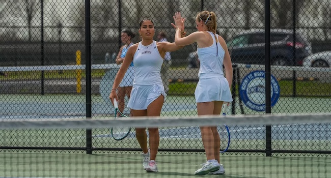 msmu women's tennis players on court celebrating